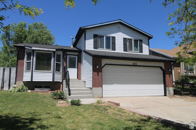423 W 180 N, Clearfield, UT 84015 - split level home featuring concrete driveway, brick siding, entry steps, and an attached garage