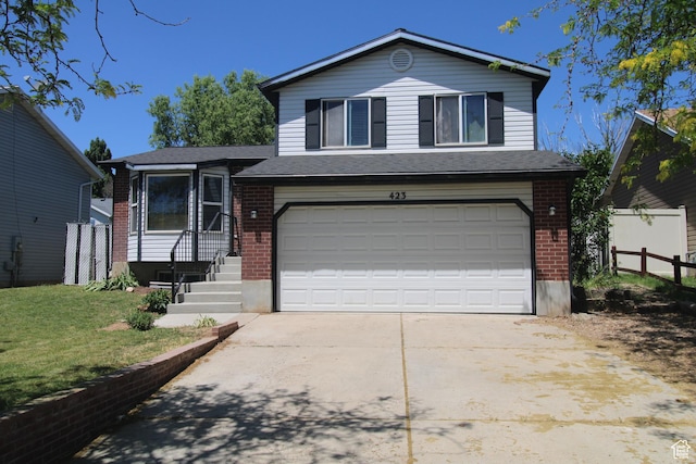 423 W 180 N, Clearfield, UT 84015 - split level home with brick siding, an attached garage, and driveway