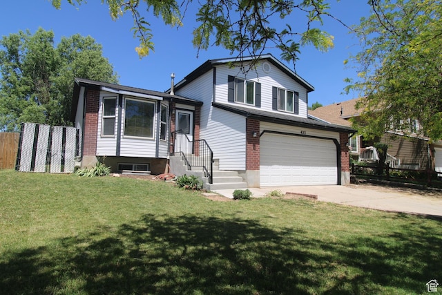 423 W 180 N, Clearfield, UT 84015 - split level home featuring an attached garage, driveway, and brick siding