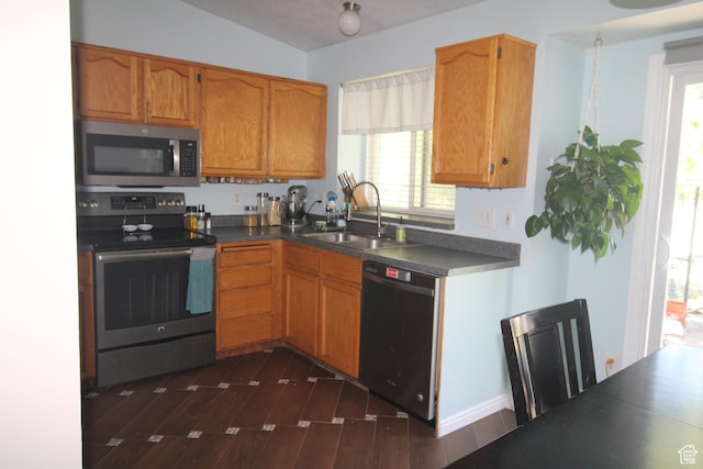 423 W 180 N, Clearfield, UT 84015 - kitchen featuring stainless steel appliances, dark countertops, dark wood-type flooring, and plenty of natural light