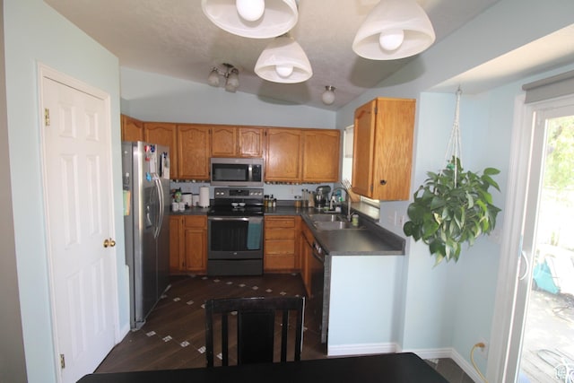 423 W 180 N, Clearfield, UT 84015 - kitchen featuring stainless steel appliances, dark countertops, brown cabinetry, dark wood finished floors, and vaulted ceiling