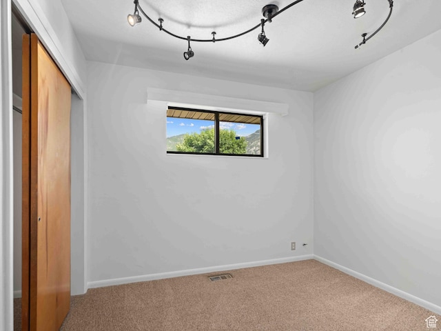 2713 N 650 E, North Ogden, UT 84414 - unfurnished bedroom featuring track lighting, carpet floors, and a closet