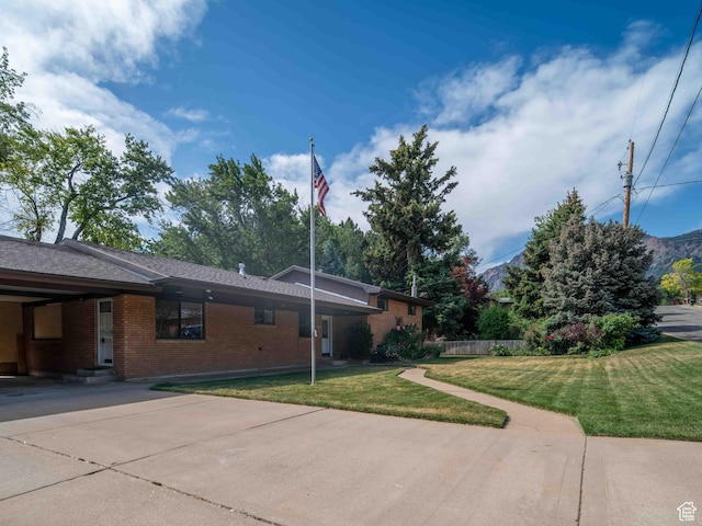 2713 N 650 E, North Ogden, UT 84414 - view of front of house featuring brick siding, a front lawn, and entry steps