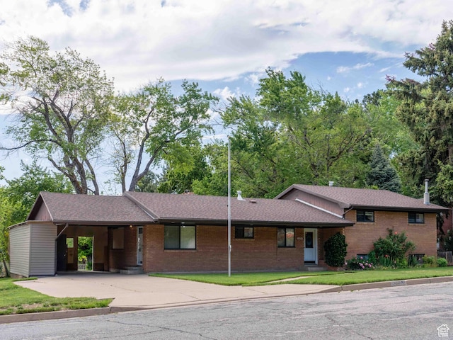 2713 N 650 E, North Ogden, UT 84414 - view of front facade with concrete driveway, brick siding, a carport, roof with shingles, and a front lawn