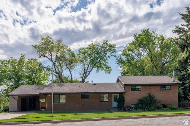 2713 N 650 E, North Ogden, UT 84414 - view of front of house with a front lawn, driveway, an attached carport, and brick siding