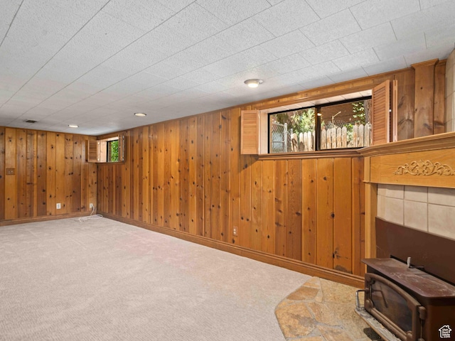 2713 N 650 E, North Ogden, UT 84414 - below grade area with a wood stove, carpet, and wood walls