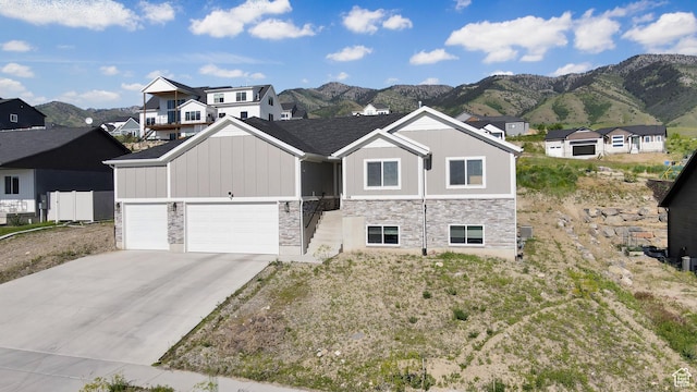 108 S 900 E, Hyde Park, UT 84318 - view of front of house with stone siding, a mountain view, and board and batten siding