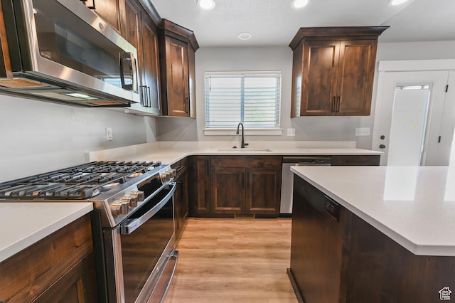 108 S 900 E, Hyde Park, UT 84318 - kitchen featuring appliances with stainless steel finishes, recessed lighting, light countertops, dark brown cabinets, and light wood-style flooring