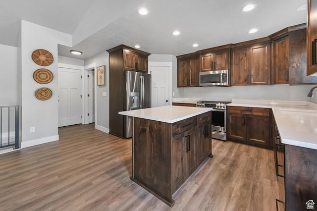 108 S 900 E, Hyde Park, UT 84318 - kitchen featuring appliances with stainless steel finishes, a kitchen island, recessed lighting, light wood finished floors, and light countertops