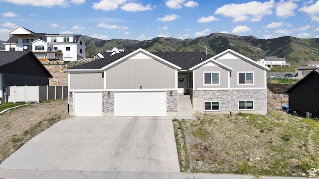108 S 900 E, Hyde Park, UT 84318 - view of front of property featuring board and batten siding, stone siding, a mountain view, and a garage