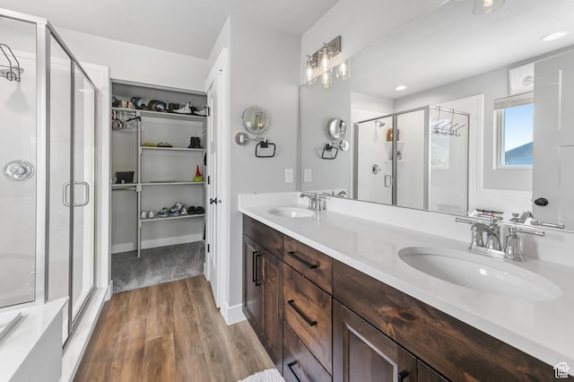 108 S 900 E, Hyde Park, UT 84318 - bathroom with a shower stall, a spacious closet, wood finished floors, and double vanity