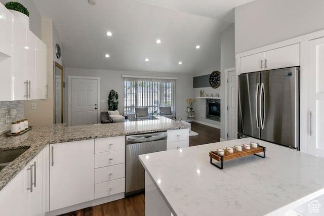 4015 S Brandon Ct, West Valley City, UT 84128 - kitchen featuring appliances with stainless steel finishes, lofted ceiling, white cabinetry, a peninsula, and recessed lighting