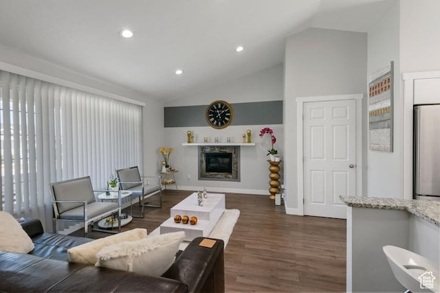 4015 S Brandon Ct, West Valley City, UT 84128 - living room with vaulted ceiling, dark wood-style floors, a glass covered fireplace, and recessed lighting