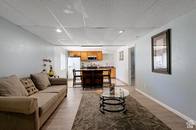 4015 S Brandon Ct, West Valley City, UT 84128 - living area with light wood-style floors, a drop ceiling, and recessed lighting