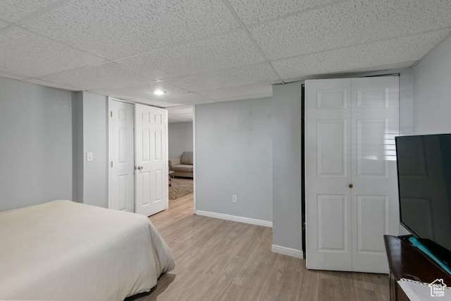 4015 S Brandon Ct, West Valley City, UT 84128 - bedroom with light wood-style floors and a drop ceiling