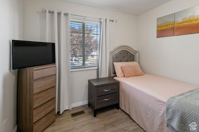4015 S Brandon Ct, West Valley City, UT 84128 - bedroom featuring light wood finished floors and baseboards