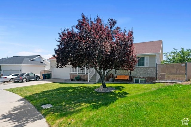 4015 S Brandon Ct, West Valley City, UT 84128 - view of property hidden behind natural elements featuring driveway, a garage, covered porch, and brick siding