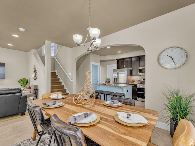 4956 W Vermillion Dr, South Jordan, UT 84009 - dining room featuring arched walkways, stairway, a chandelier, recessed lighting, and light tile patterned floors