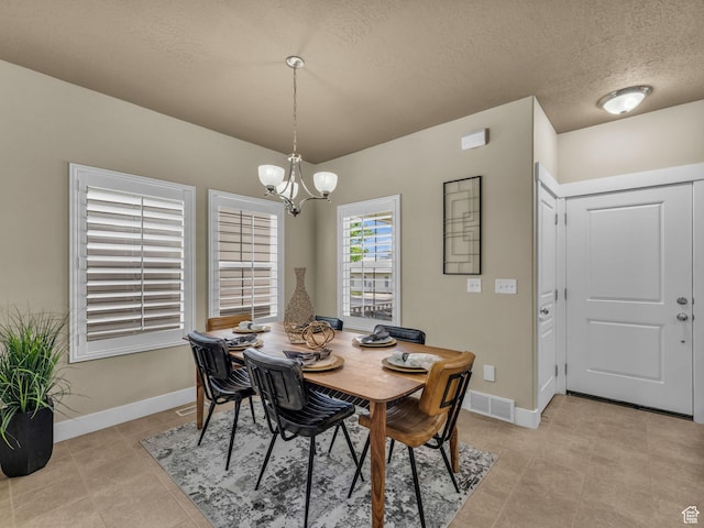 4956 W Vermillion Dr, South Jordan, UT 84009 - dining room featuring a chandelier, light tile patterned floors, and a textured ceiling
