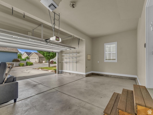 4956 W Vermillion Dr, South Jordan, UT 84009 - garage featuring a garage door opener and baseboards