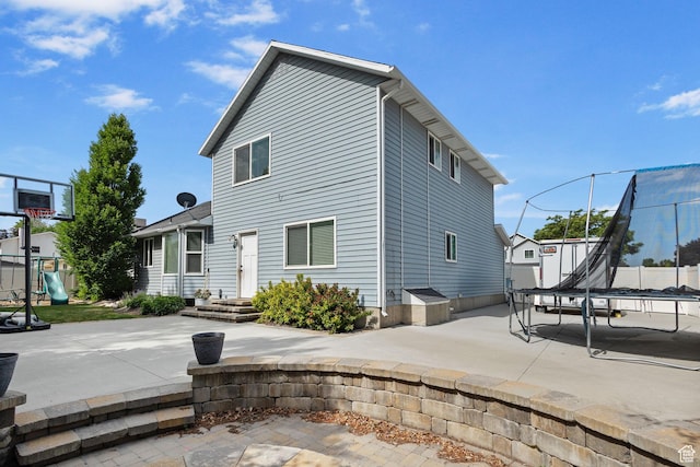 211 S 860 E, Orem, UT 84097 - rear view of house with a trampoline, a patio, and a playground