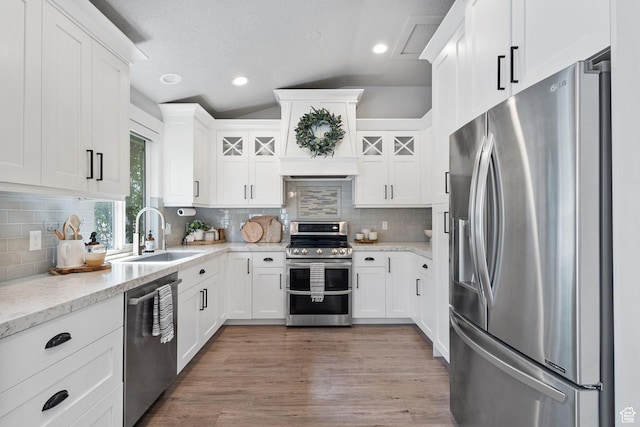 211 S 860 E, Orem, UT 84097 - kitchen with stainless steel appliances, vaulted ceiling, white cabinetry, and recessed lighting