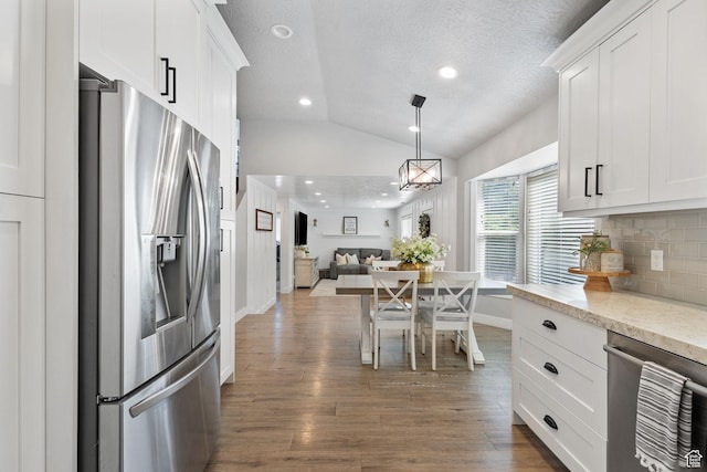 211 S 860 E, Orem, UT 84097 - kitchen with appliances with stainless steel finishes, lofted ceiling, open floor plan, backsplash, and white cabinets