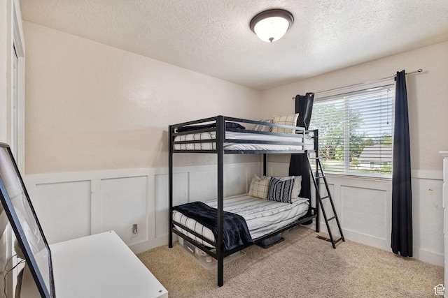 211 S 860 E, Orem, UT 84097 - bedroom featuring a textured ceiling, a wainscoted wall, light carpet, and a decorative wall