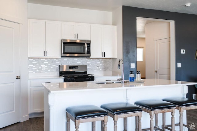 3657 E 1500 S, Spanish Fork, UT 84660 - kitchen with appliances with stainless steel finishes, light countertops, white cabinets, and tasteful backsplash