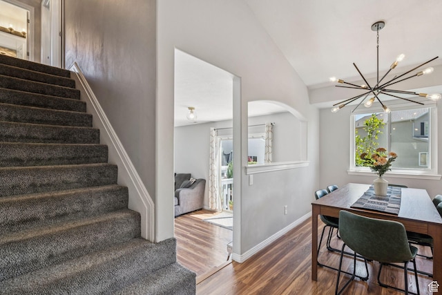 4052 W Newland Loop, Lehi, UT 84043 - dining space featuring stairs, wood finished floors, a chandelier, and lofted ceiling