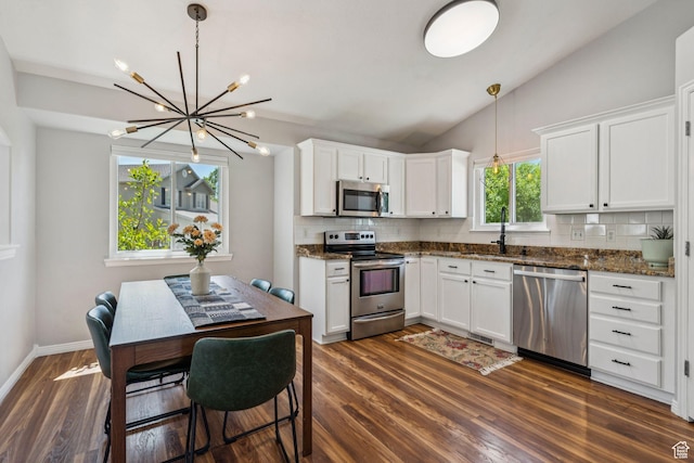 4052 W Newland Loop, Lehi, UT 84043 - kitchen featuring appliances with stainless steel finishes, backsplash, a chandelier, dark wood-style floors, and white cabinetry