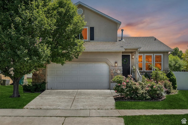 4052 W Newland Loop, Lehi, UT 84043 - view of front facade featuring stucco siding, stone siding, driveway, a garage, and a yard