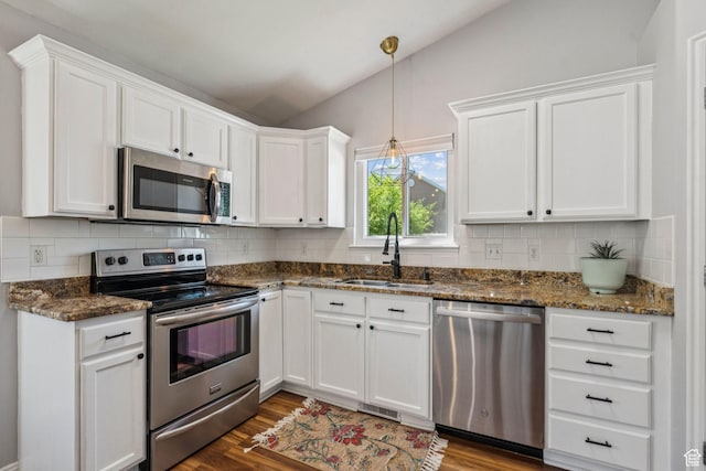 4052 W Newland Loop, Lehi, UT 84043 - kitchen featuring stainless steel appliances, vaulted ceiling, white cabinetry, backsplash, and dark wood-type flooring