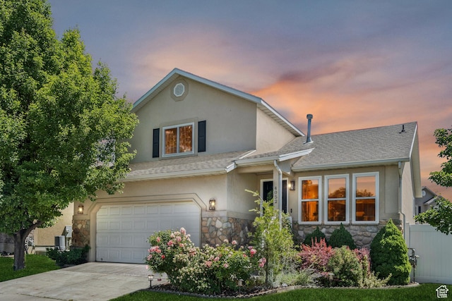 4052 W Newland Loop, Lehi, UT 84043 - view of front of property with stone siding, stucco siding, an attached garage, driveway, and a shingled roof