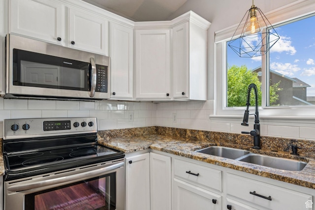 4052 W Newland Loop, Lehi, UT 84043 - kitchen featuring stainless steel appliances, white cabinetry, backsplash, and dark stone counters