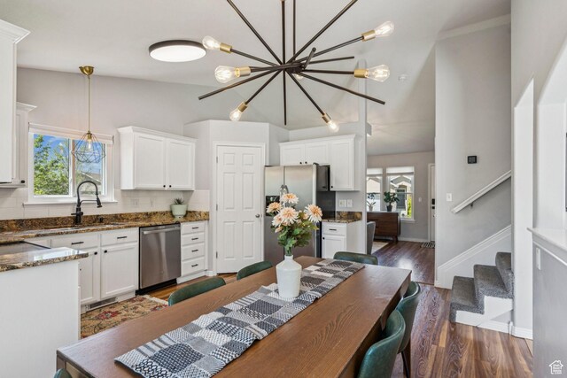 4052 W Newland Loop, Lehi, UT 84043 - kitchen with appliances with stainless steel finishes, white cabinets, dark wood-style floors, and pendant lighting