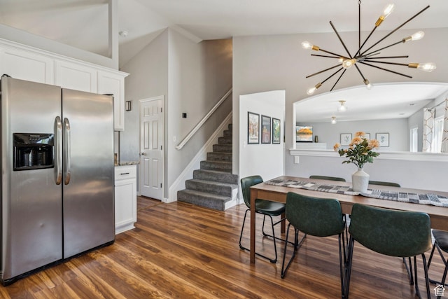 4052 W Newland Loop, Lehi, UT 84043 - dining space featuring a chandelier, stairway, dark wood finished floors, and high vaulted ceiling
