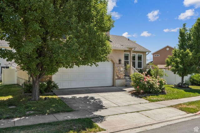 4052 W Newland Loop, Lehi, UT 84043 - view of property hidden behind natural elements with stone siding, concrete driveway, a garage, stucco siding, and roof with shingles