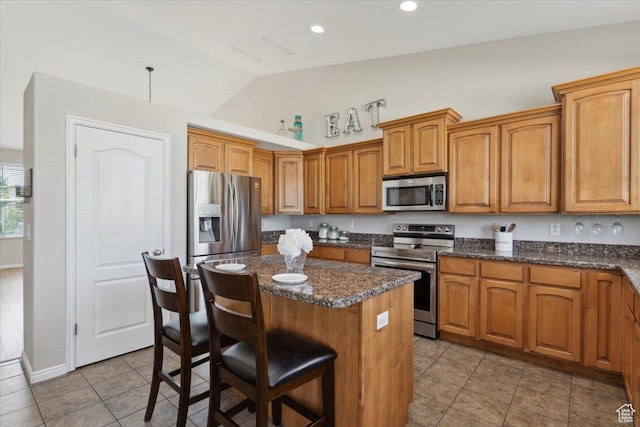4124 S 3475 W, West Haven, UT 84401 - kitchen with appliances with stainless steel finishes, lofted ceiling, a center island, a breakfast bar area, and light tile patterned floors