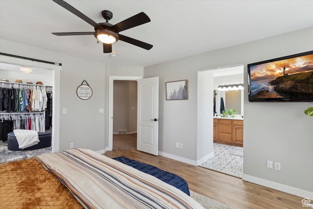 4124 S 3475 W, West Haven, UT 84401 - bedroom featuring light wood finished floors, a spacious closet, ensuite bath, a closet, and ceiling fan