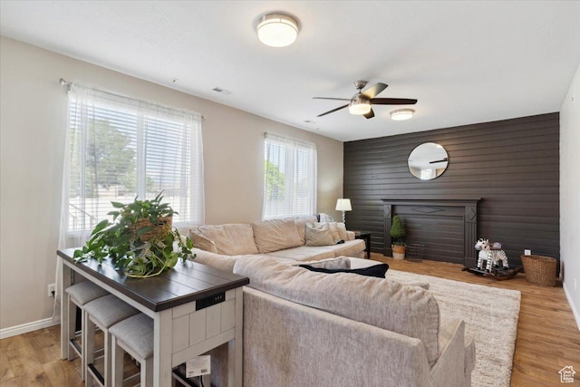 4124 S 3475 W, West Haven, UT 84401 - living area featuring an accent wall, ceiling fan, and light wood-type flooring