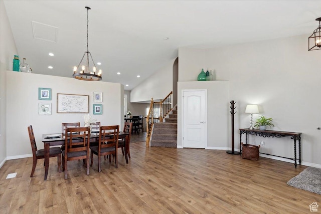4124 S 3475 W, West Haven, UT 84401 - dining space with a chandelier, stairs, light wood finished floors, recessed lighting, and vaulted ceiling
