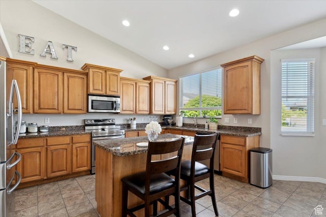 4124 S 3475 W, West Haven, UT 84401 - kitchen with stainless steel appliances, a center island, a kitchen bar, lofted ceiling, and recessed lighting