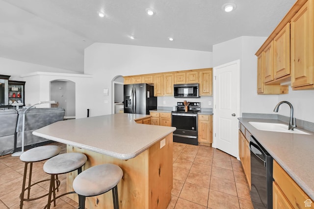 4317 S 3350 W, West Haven, UT 84401 - kitchen featuring black appliances, arched walkways, a kitchen breakfast bar, a center island, and light brown cabinets
