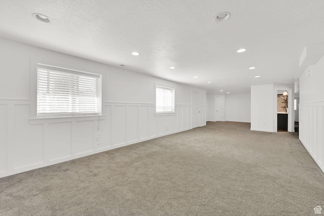 4317 S 3350 W, West Haven, UT 84401 - empty room featuring a decorative wall, carpet, a wainscoted wall, recessed lighting, and a textured ceiling