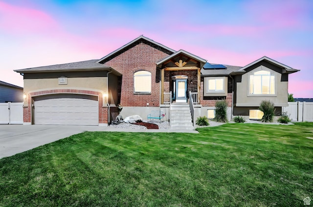 4317 S 3350 W, West Haven, UT 84401 - view of front of property featuring concrete driveway, roof mounted solar panels, a garage, brick siding, and stucco siding