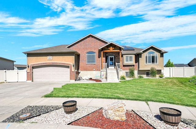 4317 S 3350 W, West Haven, UT 84401 - view of front of property featuring concrete driveway, solar panels, a garage, brick siding, and a gate