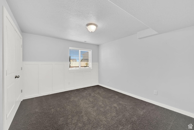4317 S 3350 W, West Haven, UT 84401 - unfurnished room with a textured ceiling, wainscoting, and dark colored carpet