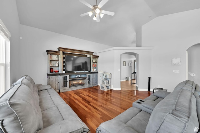 4317 S 3350 W, West Haven, UT 84401 - living area featuring arched walkways, a ceiling fan, wood finished floors, lofted ceiling, and a glass covered fireplace