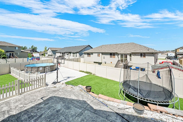 4317 S 3350 W, West Haven, UT 84401 - fenced backyard featuring a trampoline, a residential view, and a patio area